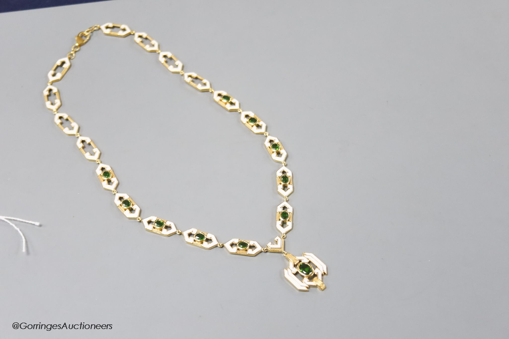 A modern stylish 925 gilt white metal, green paste and enamel set necklace, 50cm